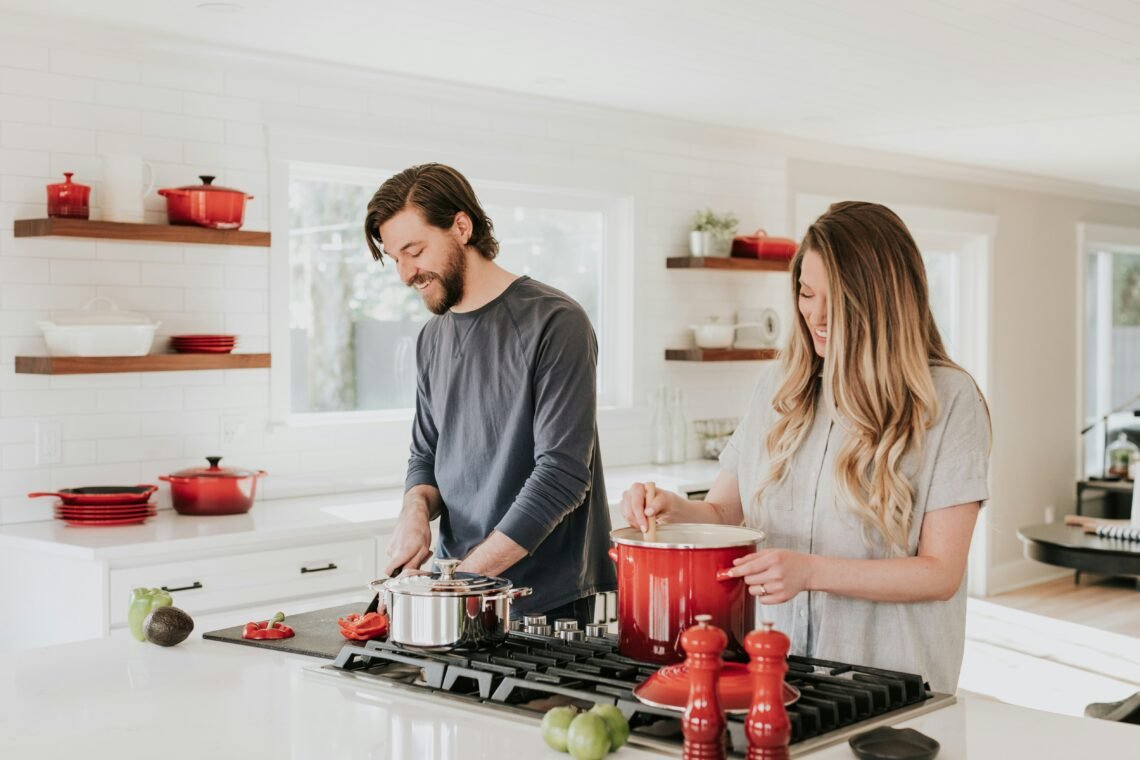 A couple cooking in their kitchen.