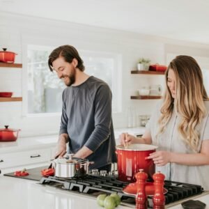 A couple cooking in their kitchen.