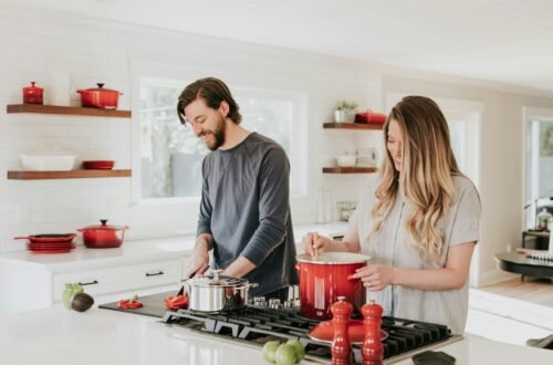 A couple cooking in their kitchen.